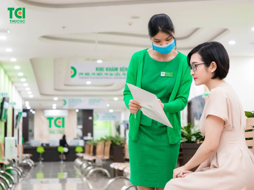 Consultant assisting a client with treatment records at Thu Cuc TCI for the Best intimate area whitening